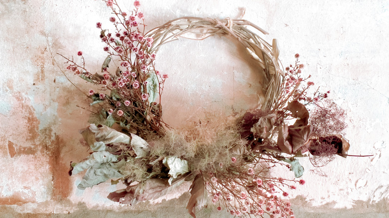 A woven wreath decorated with dried flowers