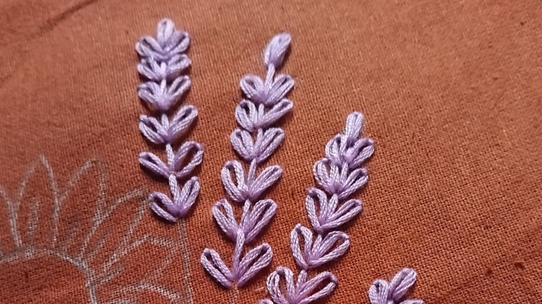 Simple embroidered lavender on a red cloth