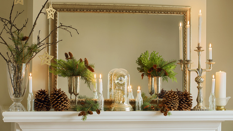 A mantel decorated for the winter with evergreen branches