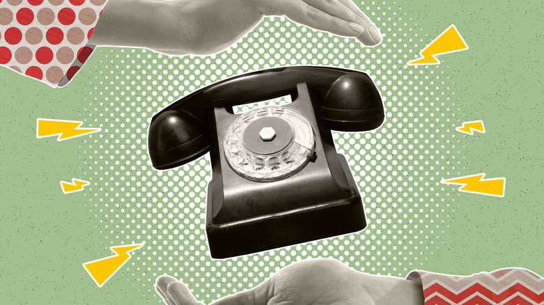 Hands around retro phone
