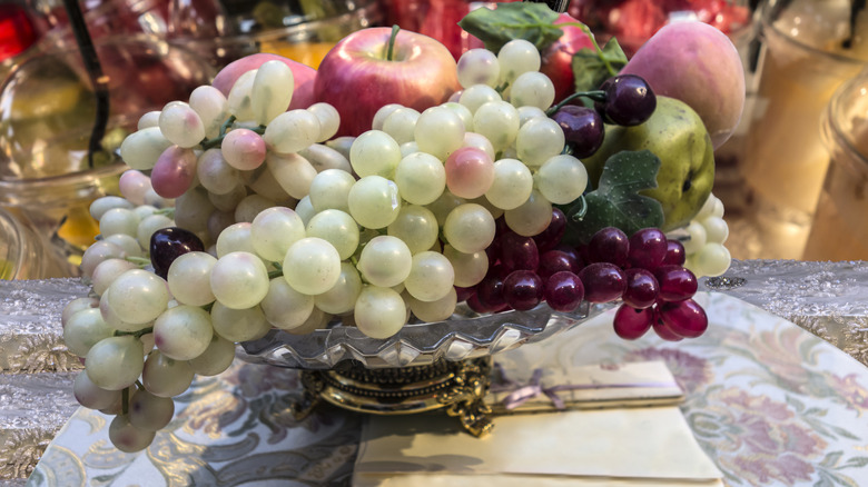Faux fruit in a cup on display