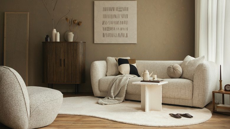 A tan and beige living room with a textured sofa.