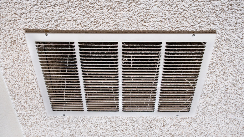 Ceiling air vent cover covered in dust