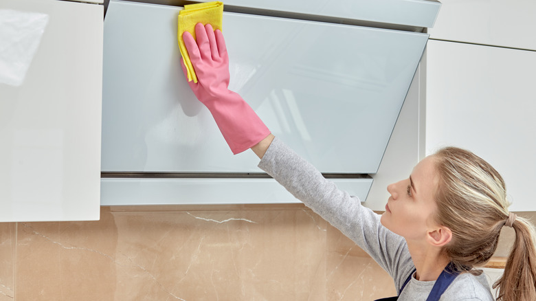 woman cleans kitchen area