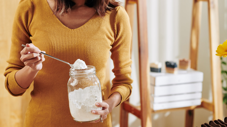 Woman scooping baking soda