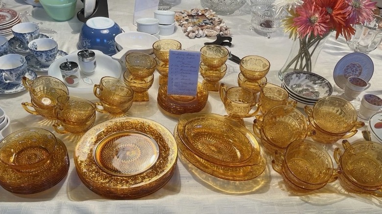 set of amber colored Depression glass on a table