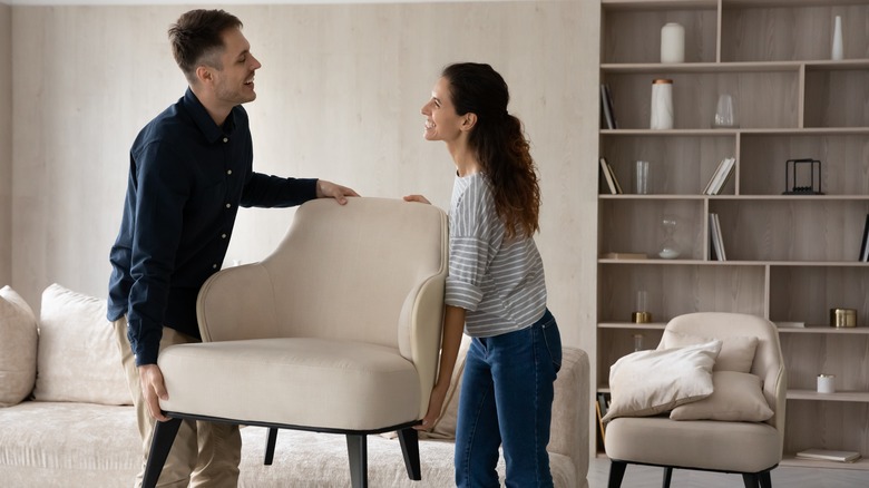 people moving beige armchair