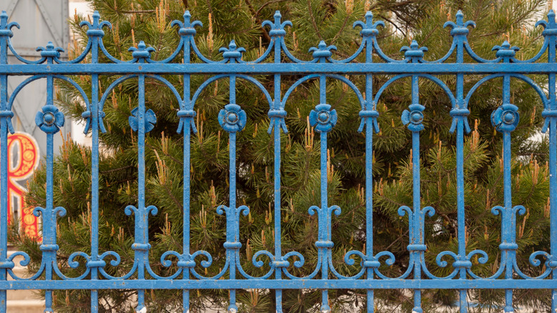 Blue ornate wrought iron fence