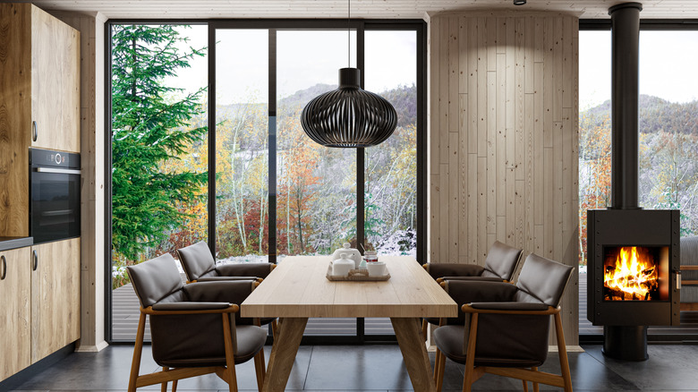 Wood drenched dining room with complementary wood table and chairs