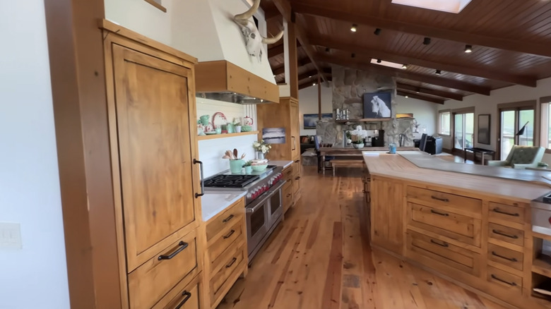 Side view of fridges hidden behind wooden paneling