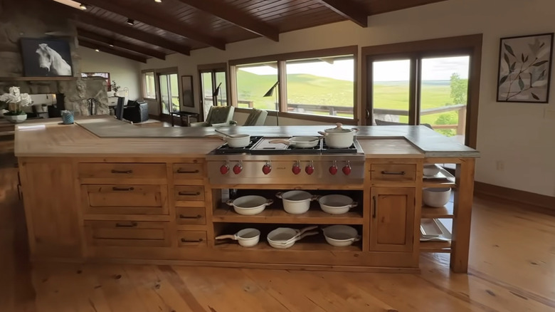 White pots and pans stored in wooden island