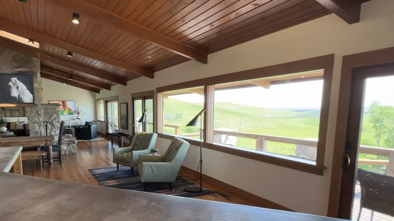 Large windows in Ree Drummond's Lodge Kitchen looking out over green prairie.