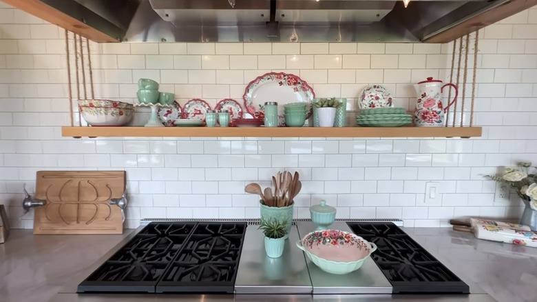 Floral dish set stored above a stove