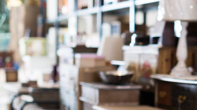 A row of tables is lined up in an antique store