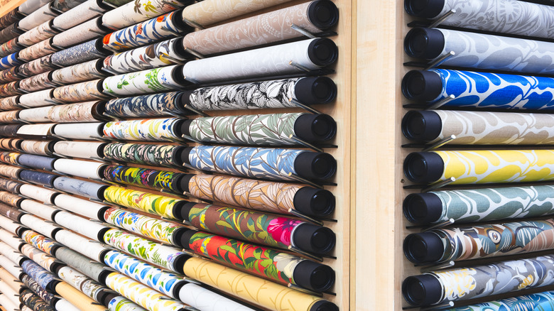 Various wallpaper rolls hanging in a store
