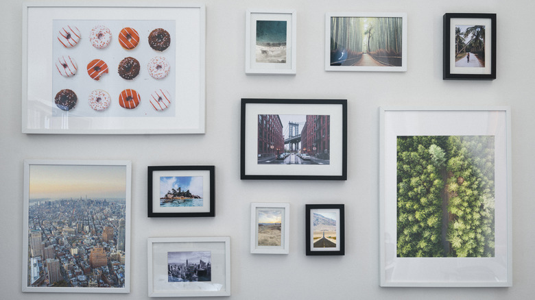 A cluttered gallery wall with mismatched art