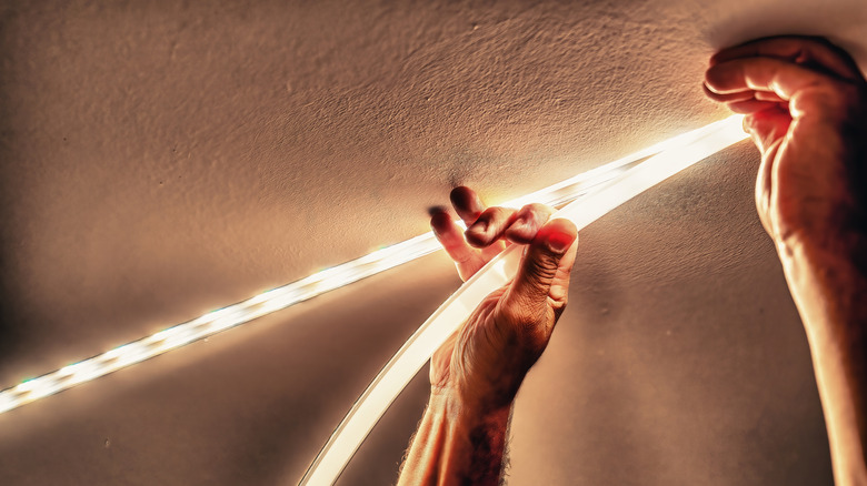 A person installing LED strip lighting
