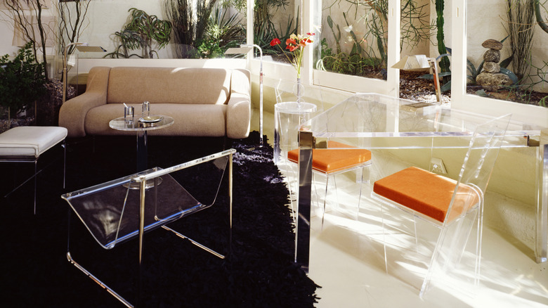A living room with several acrylic furniture pieces