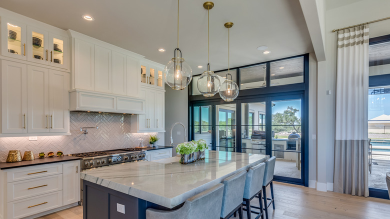 A kitchen is illuminated by under-cabinet, task, and pendant lighting