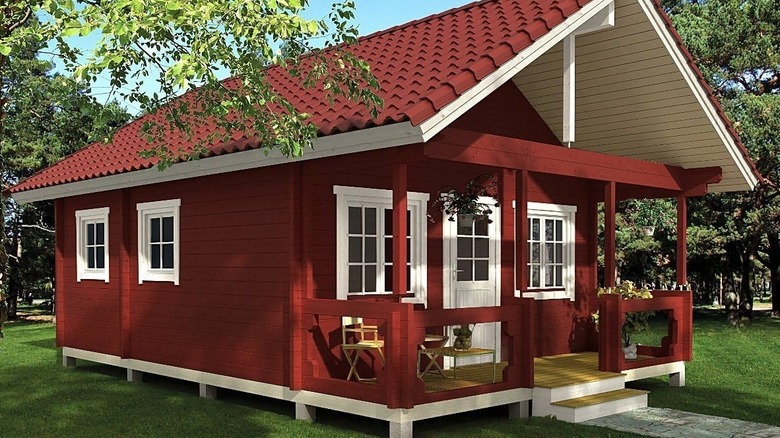 Allwood Timberline cabin with porch and loft in a beautiful garden setting.