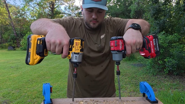 A man testing DeWalt and Craftsman impact drivers side-by-side