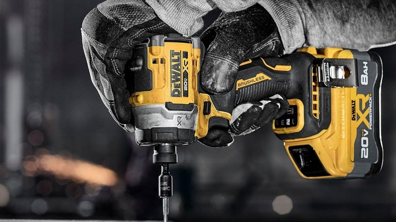 A person using a DeWalt impact driver