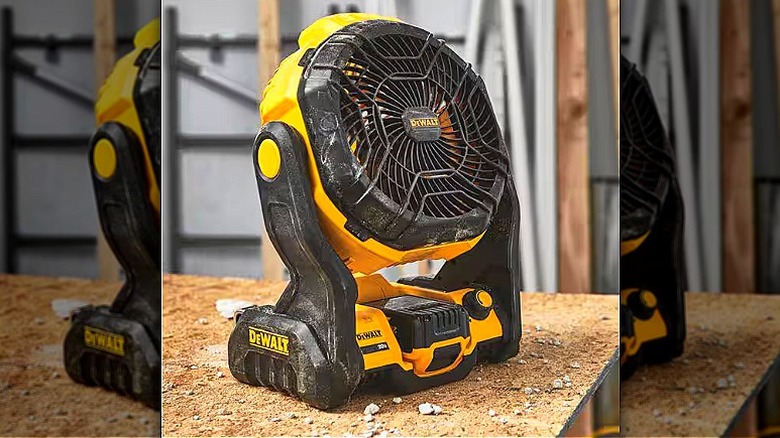 A Dewalt jobsite fan sits on a work table at a worksite