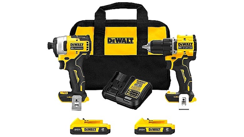 A DeWalt product photo depicting a pair of power tools, battery and charger, and case