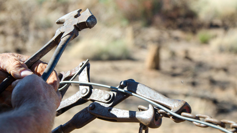 Well-work fencing pliers and a fence stretcher in use in Australia's Outback