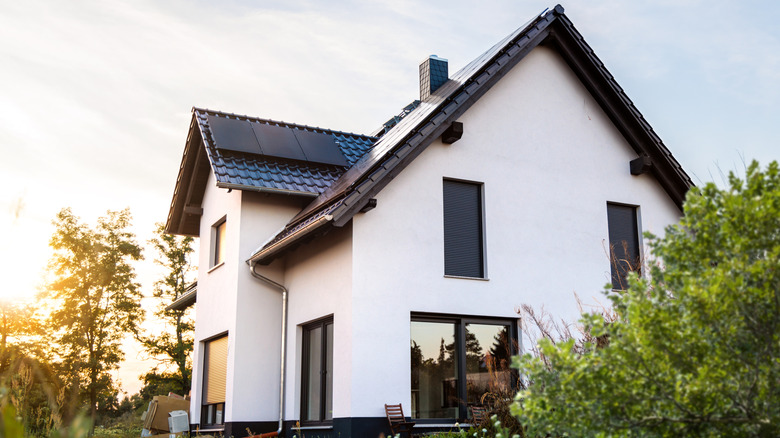A white house with black trim on a sunny day