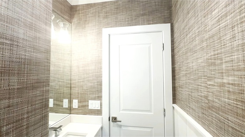 Bathroom space with grasscloth wall paper.