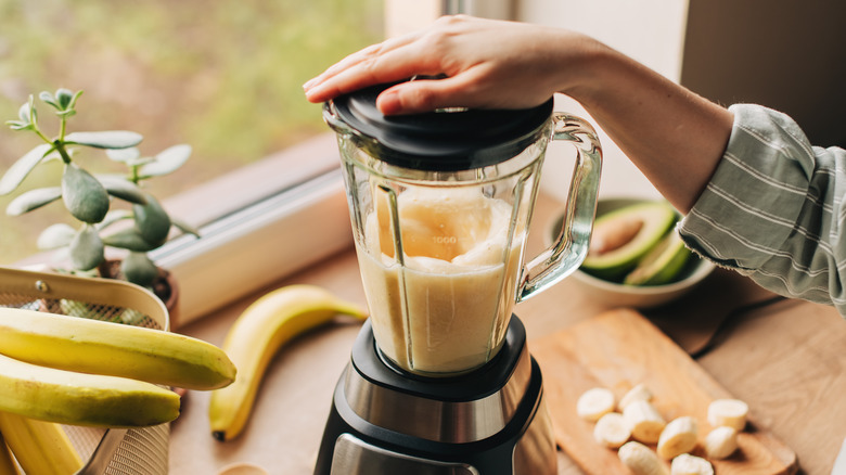 a countertop blender with blended fruit inside