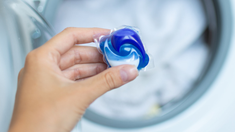 Woman holding detergent pod