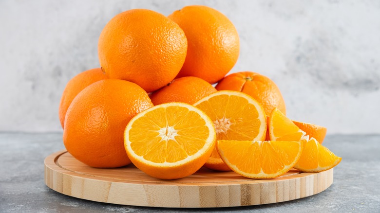 oranges displayed on wooden tray