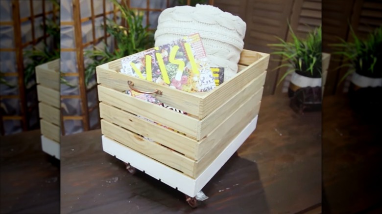 A DIY wooden storage crate with wheels.