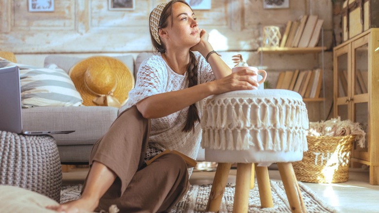 A woman sitting in a boho-inspired room