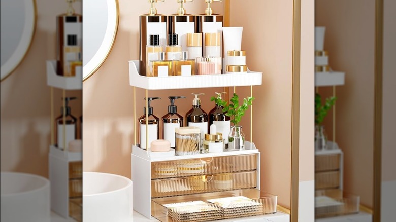 The StorBin bathroom organizer with bottles of personal care products