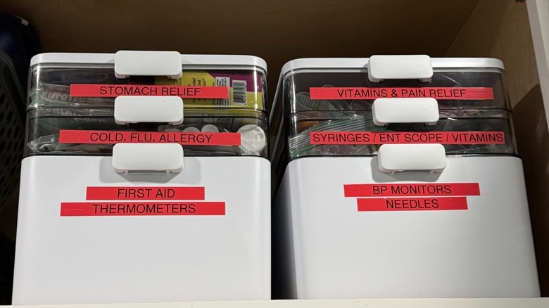 two medicine organizers with red labels