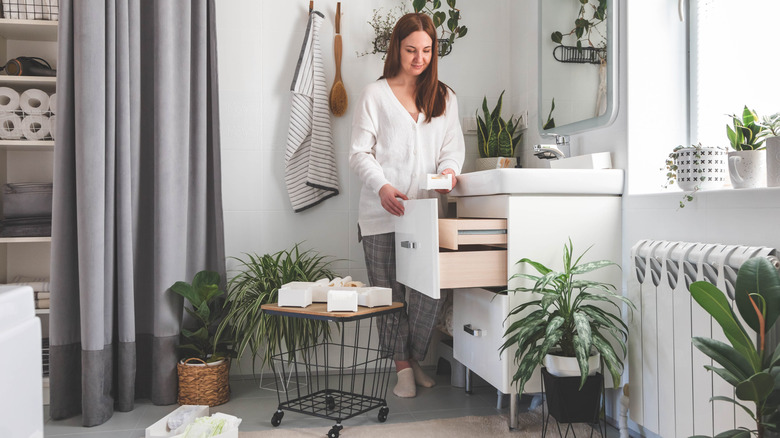 Young woman organizing her bathroom