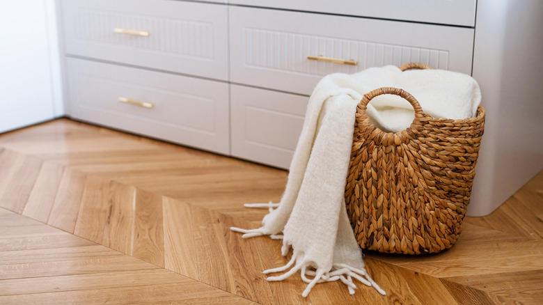 Throw blanket in a basket on the floor