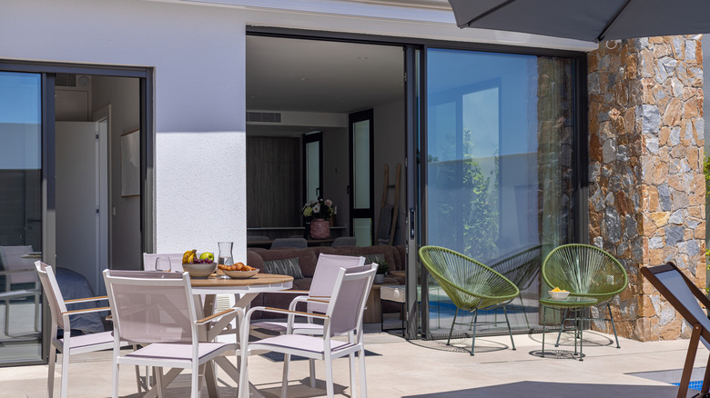 Open sliding glass doors near a patio