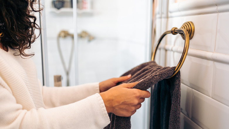 Woman hanging towel on ring