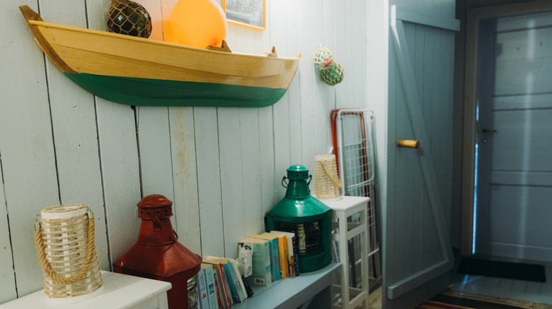 Nautical rustic entryway with books, oil lamps, and boat decor