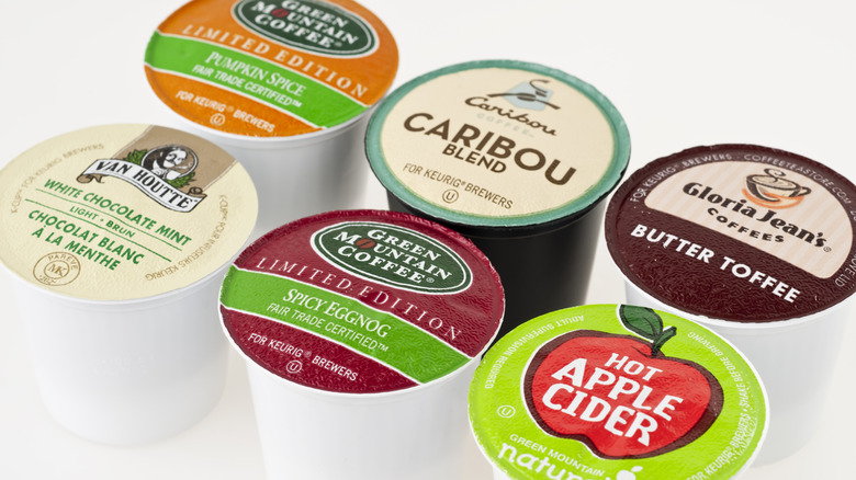 six flavors of K-Cups on white background