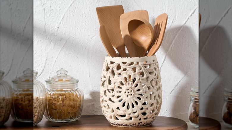 rustic utensil crock holding wooden cooking tools