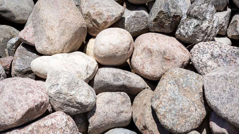 Rounded rocks, in shades of brown, white, and gray, are in a pile.