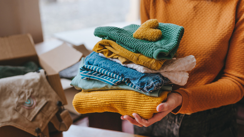 Woman holding old fabric scraps