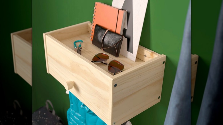 IKEA RAGGBERG in an entryway with sunglasses and a vest hanging on the coat rack below.