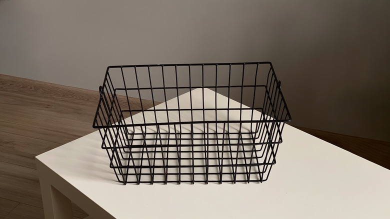 Close up of a black wire basket on a table