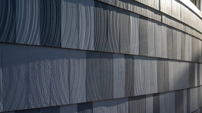 Gray composite or faux cedar shake siding used on a home